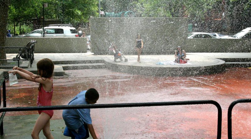 kids at sprinklers on playground