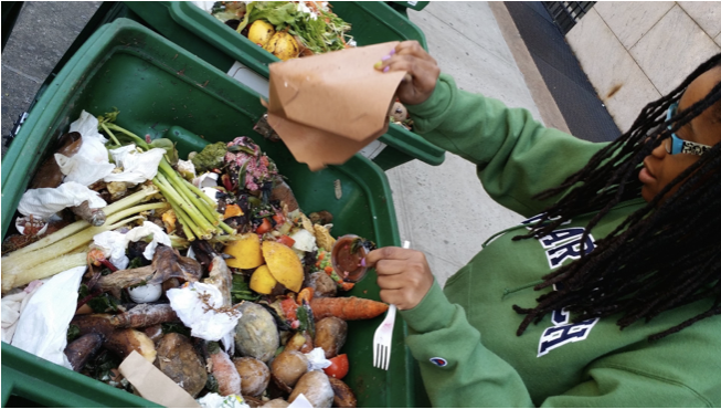 woman dumping food leftovers into food scraps bin