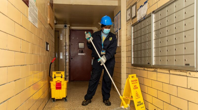 Caretaker mopping hallway
