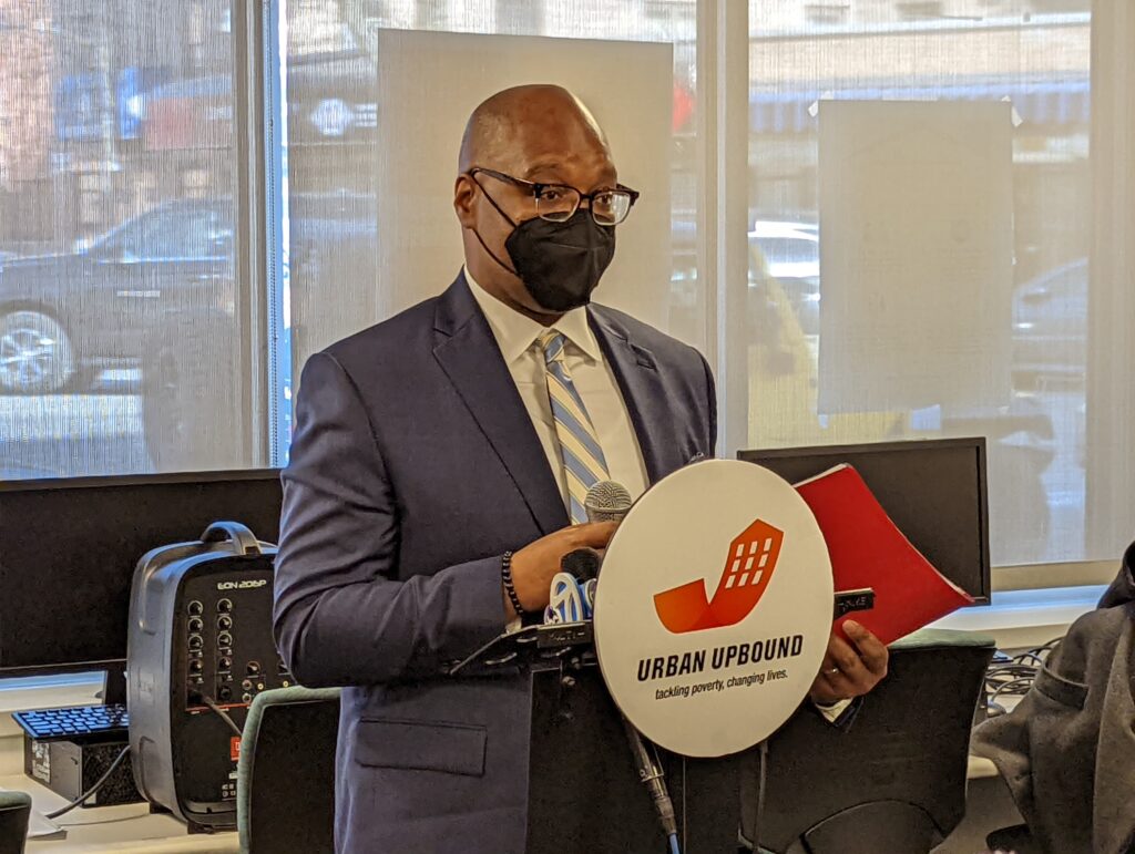 man wearing mask standing at podium