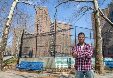 man standing in front of buildings