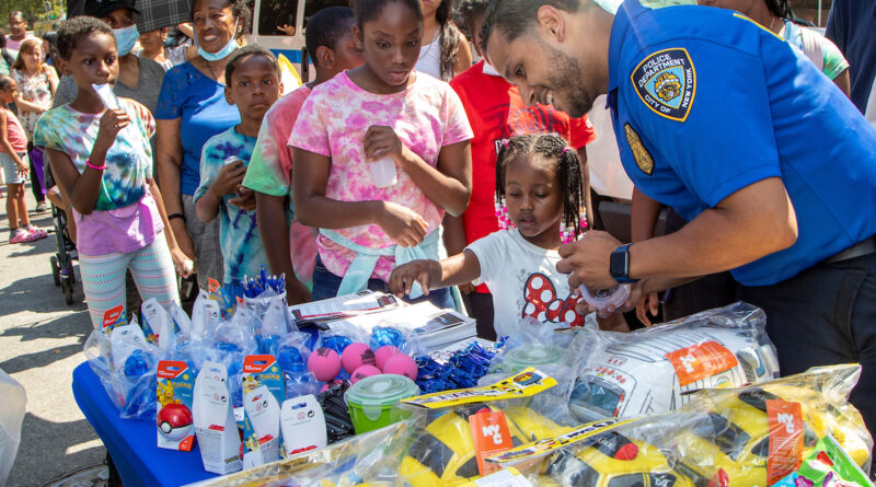 police officer giving toys to children