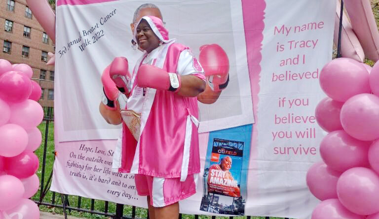 a woman dressed up in pink boxer's outfit and pink gloves