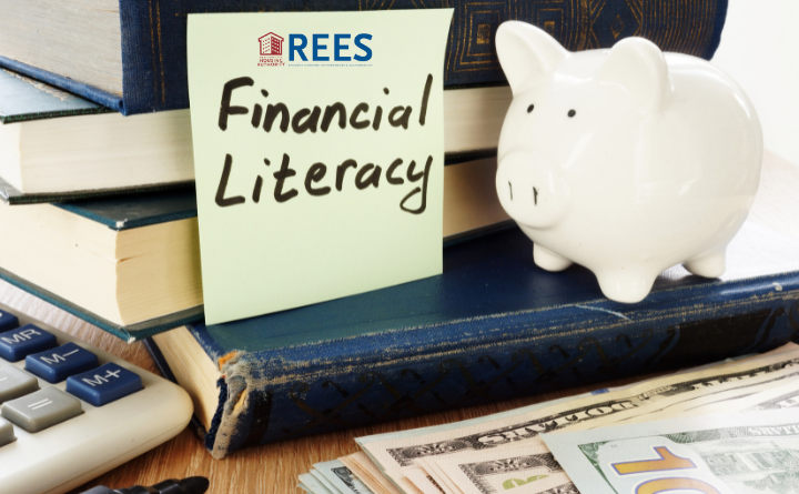 image with piggy bank, books, money, and a post it note with "Financial Literacy" and the NYCHA REES logo on it
