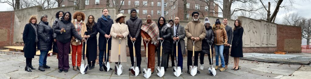 group of people holding shovels