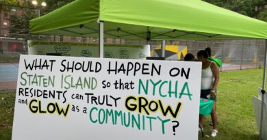 sign with text: "What should happen on Staten Island so that NYCHA residents can truly grow and glow as a community?"