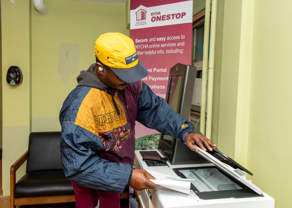 man using the print/copy feature of the Self-Service Kiosk