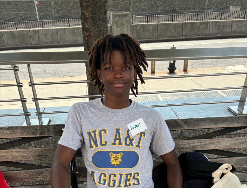 young man seated on a bench