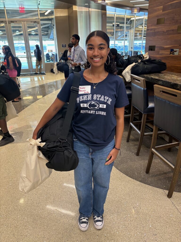 young woman holding a duffel bag