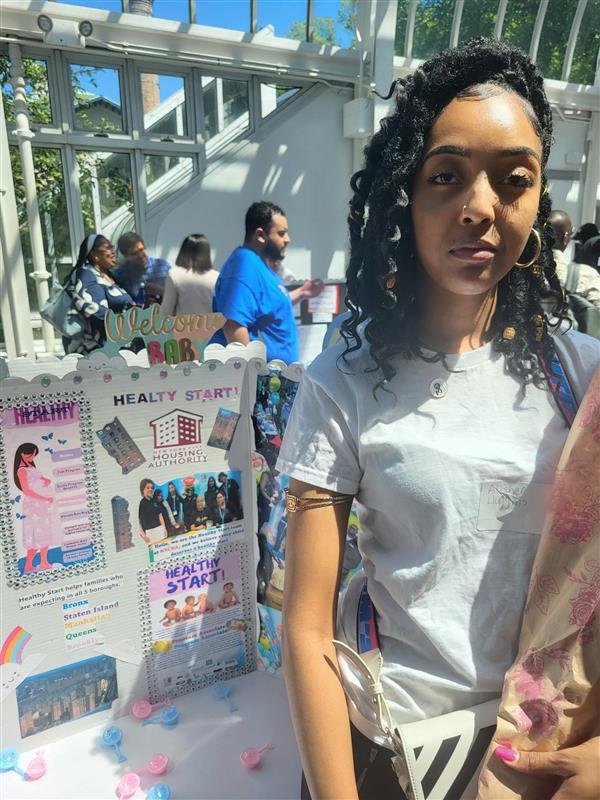 one person standing in front of a posterboard presentation