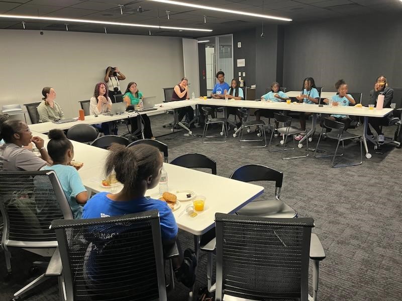 students seated in conference room