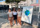 three girls in front of large poster board on an easel