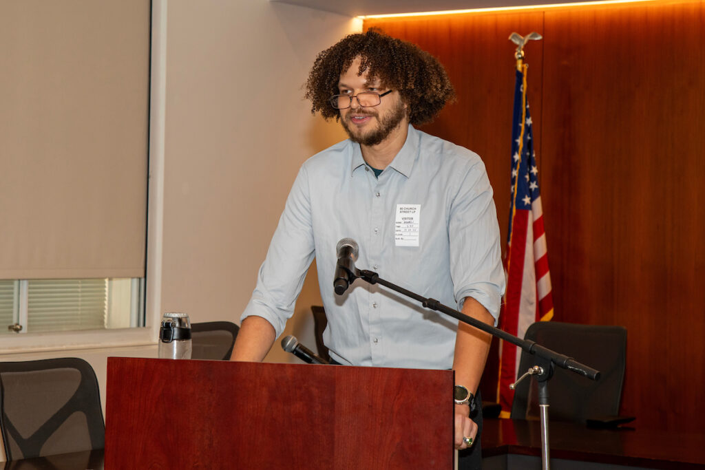 man speaking at podium