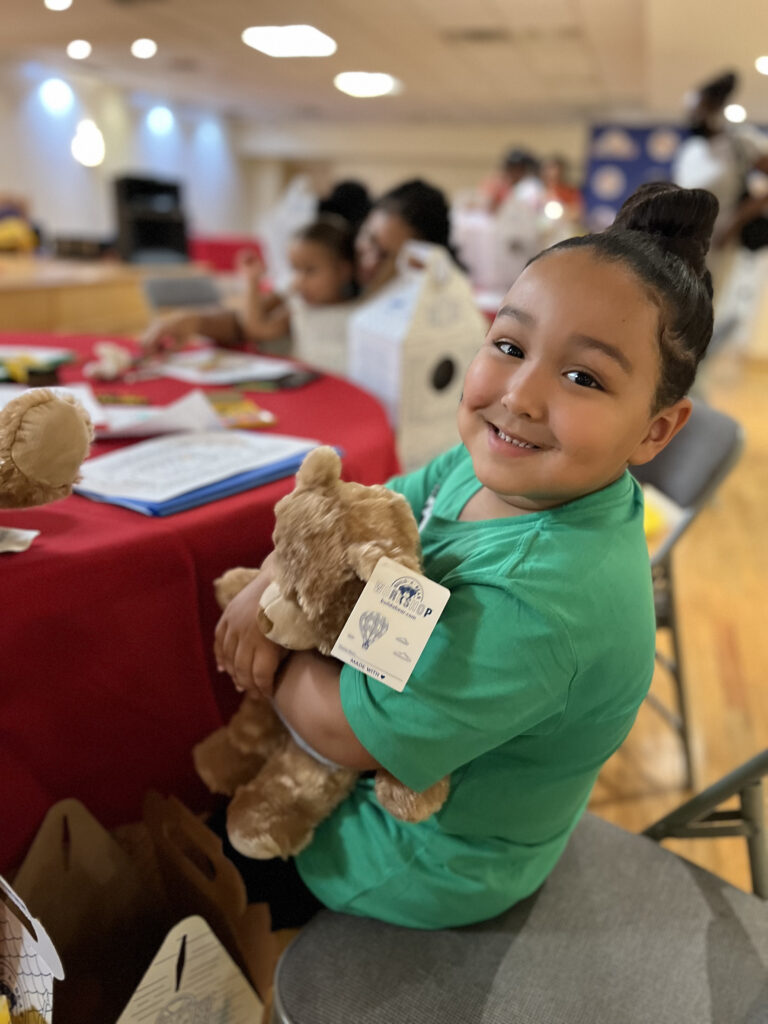 child holding teddy bear