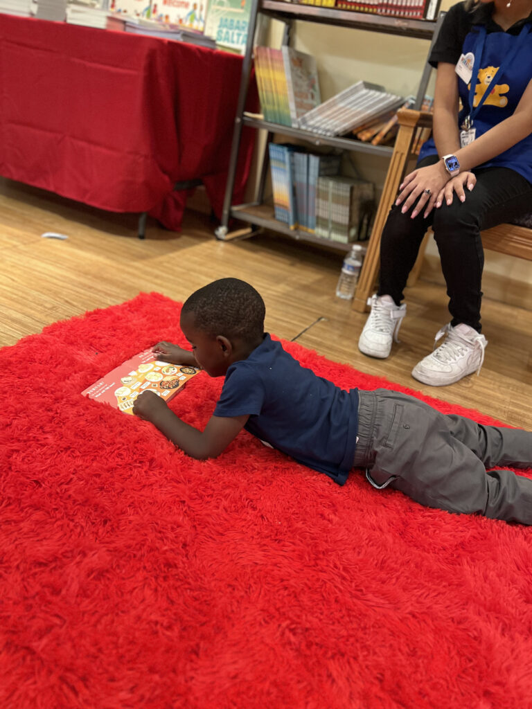 child reading a book on a rug