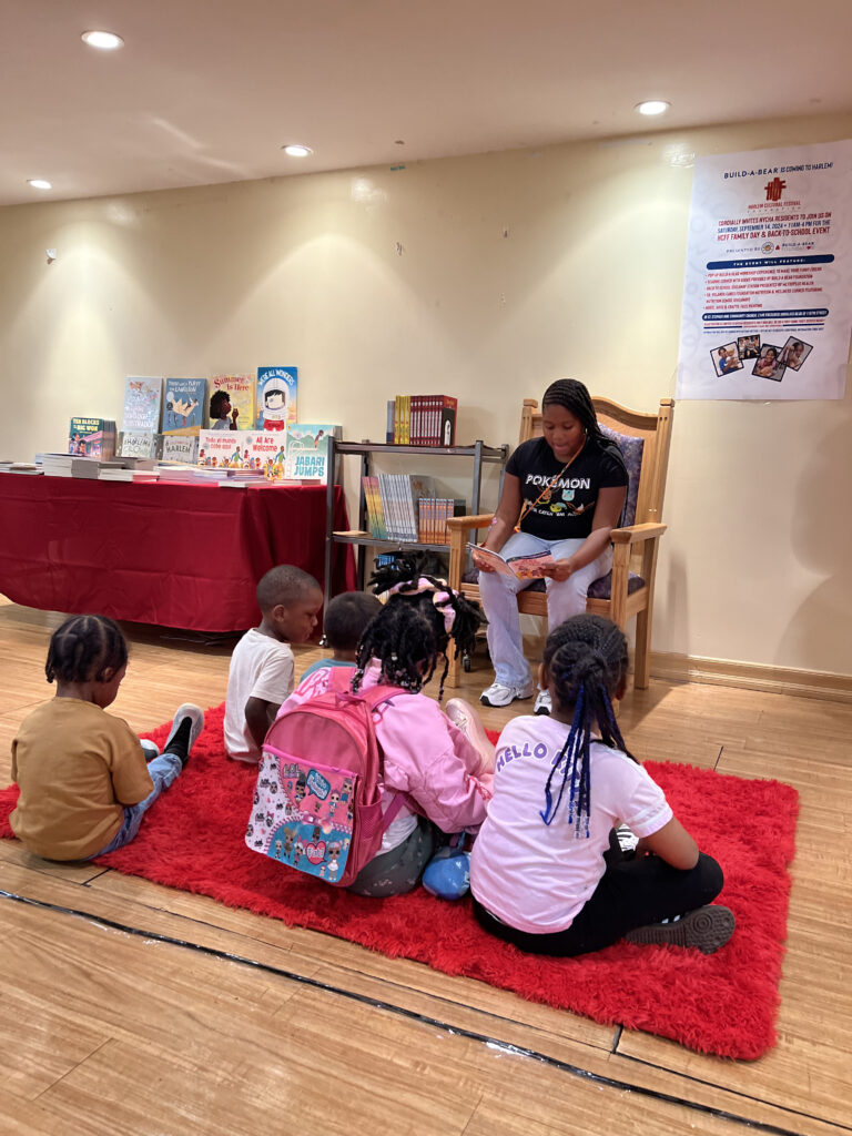 older child reading to younger children