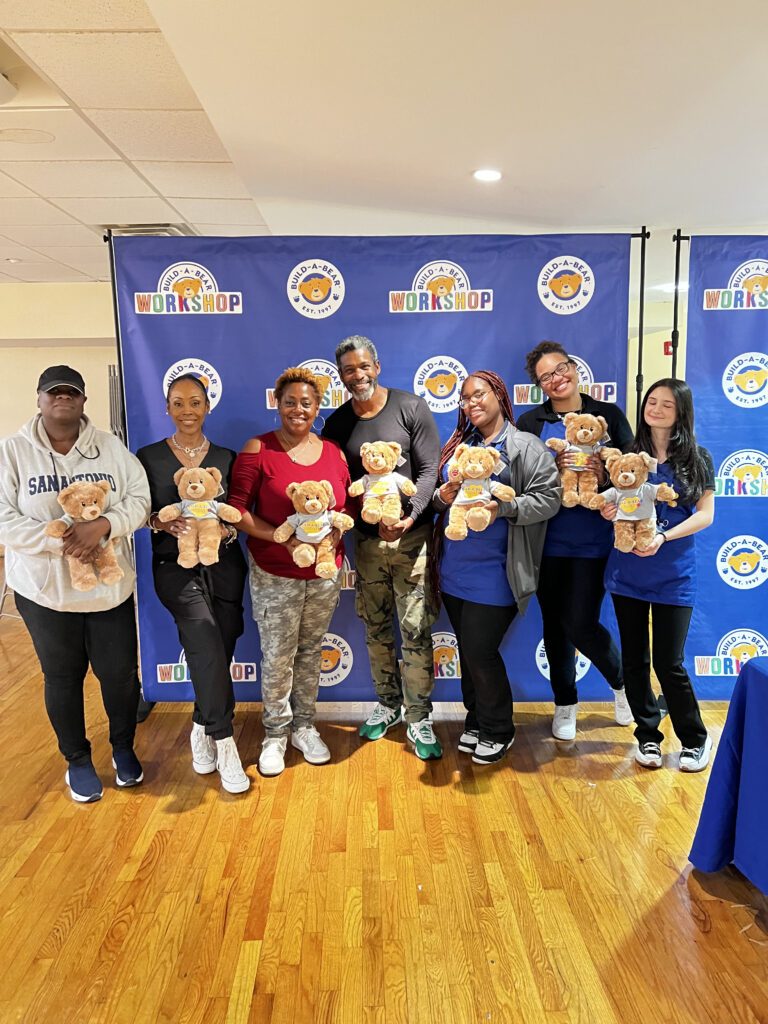 group of people holding teddy bears