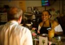 woman behind a counter serving a customer