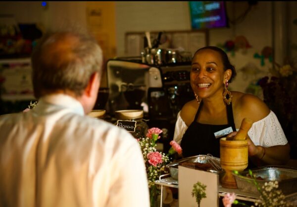 woman behind a counter serving a customer