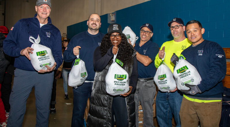 group of people holding turkeys