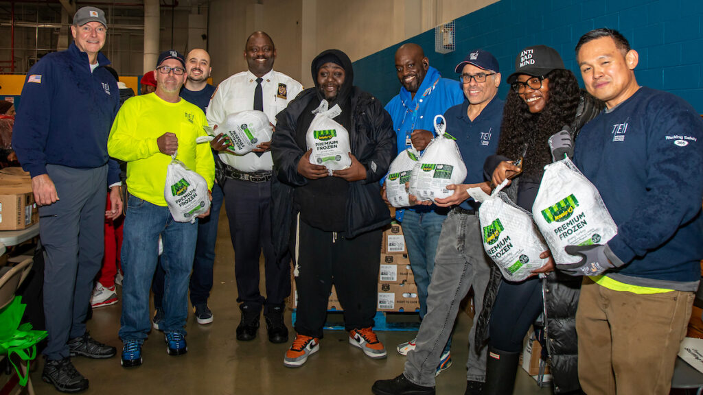 group of people holding turkeys