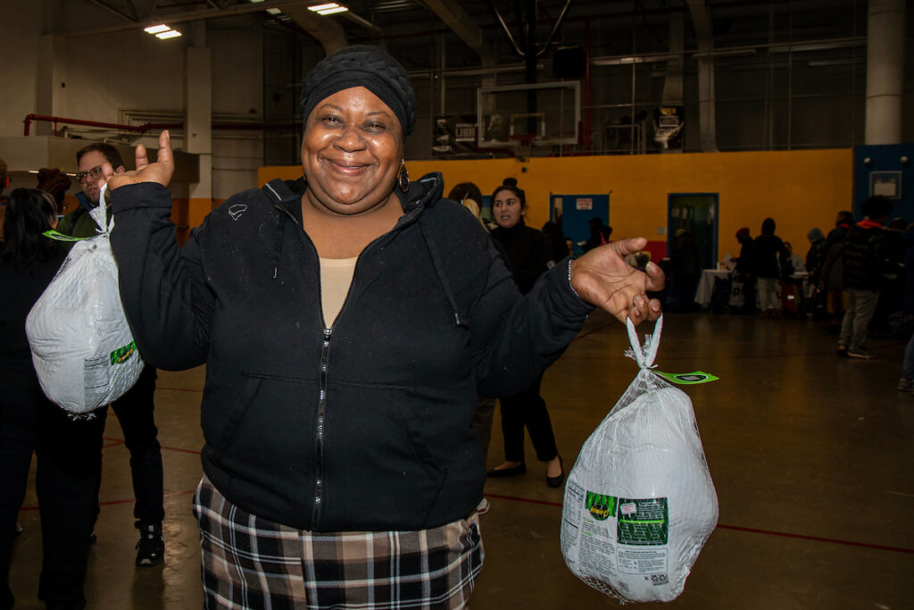 woman holding two turkeys