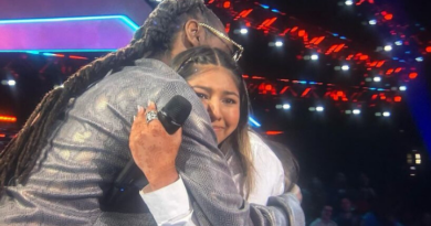 teen girl hugging man with locs (Snoop Dogg)