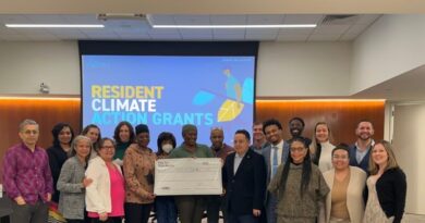 group of people in front of screen with the text, "Resident Climate Action Grants"