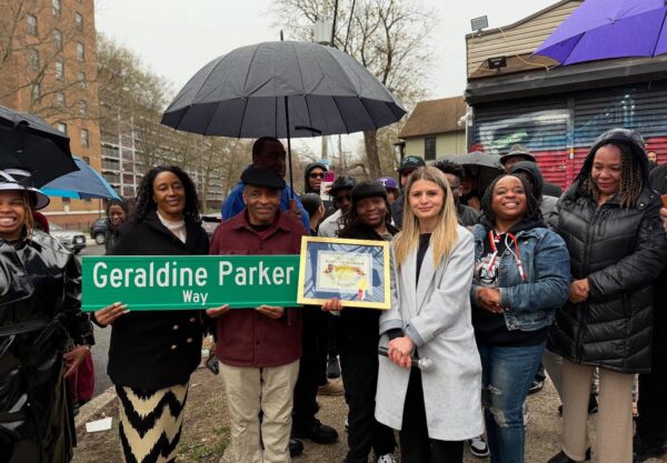 people holding street sign that says Geraldine Parker Way