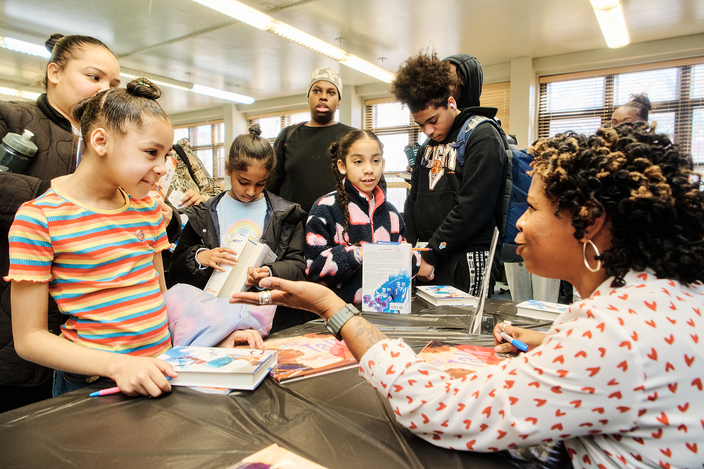 children getting their books signed by a woman author