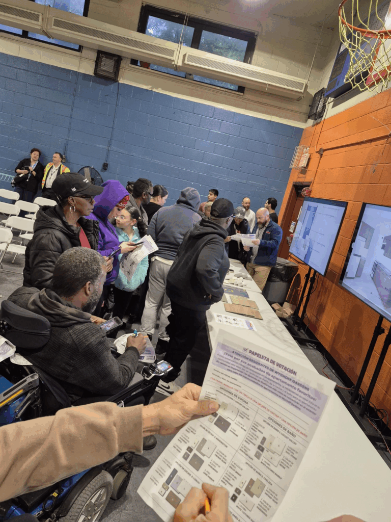 group of people in auditorium with screens