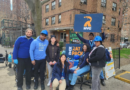 group of people holding up signs for NYC Rat Pack