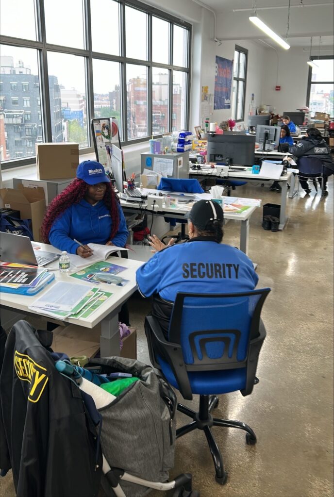 two people sitting at a desk in an office