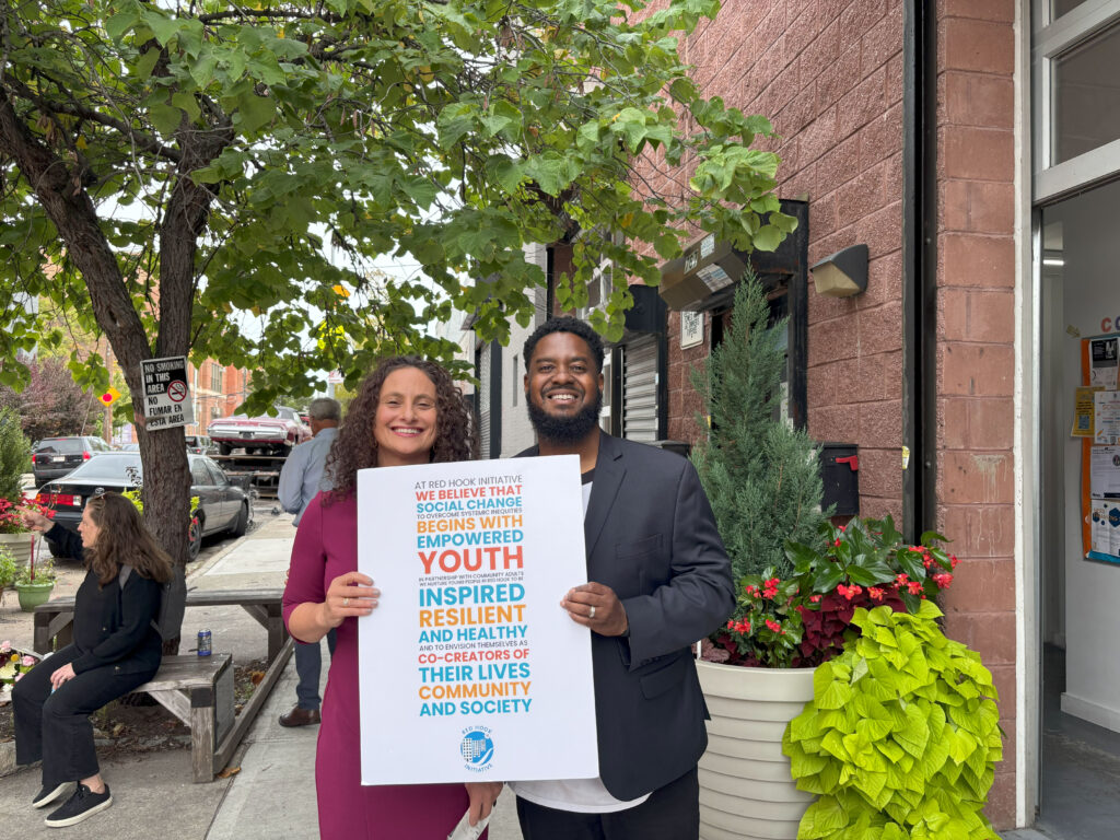 two people holding signs