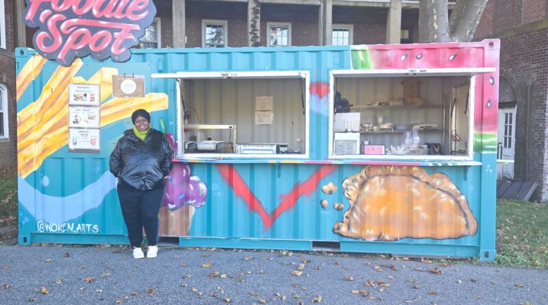 woman standing in front of decorated shipping container