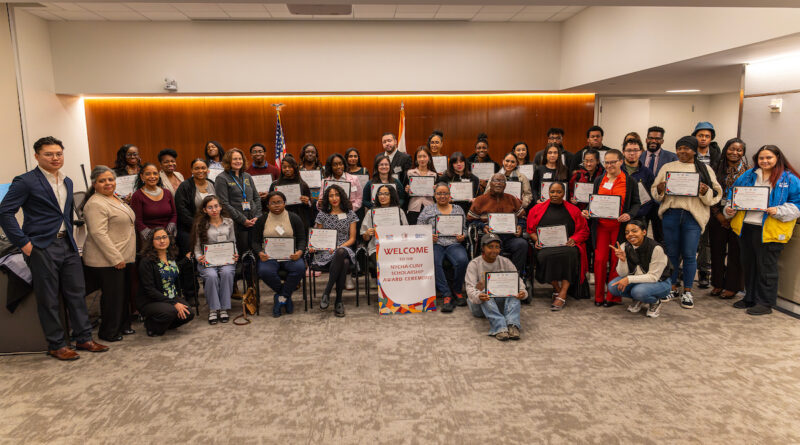 group of people holding certificates