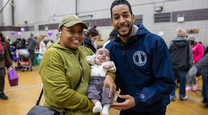 two people with a baby