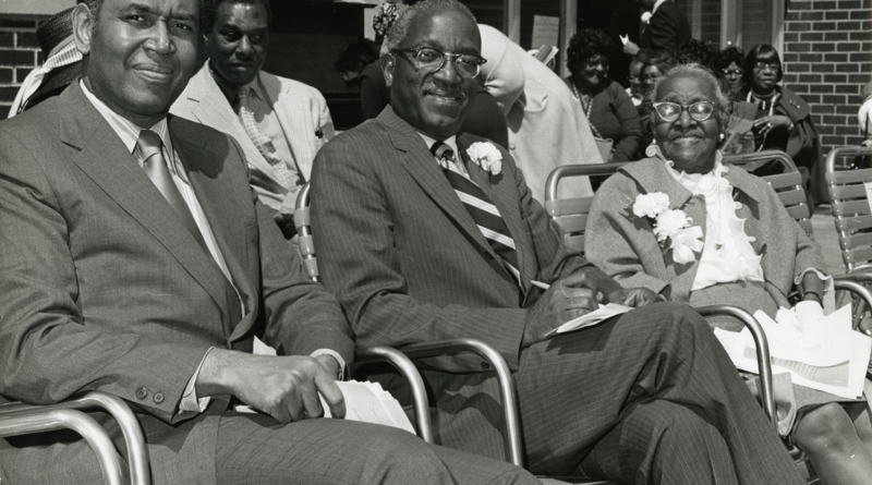black and white photo of three seated people