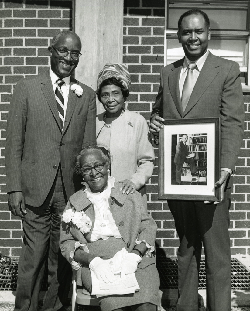 black and white photo of four people