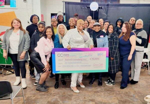 group of women holding large check