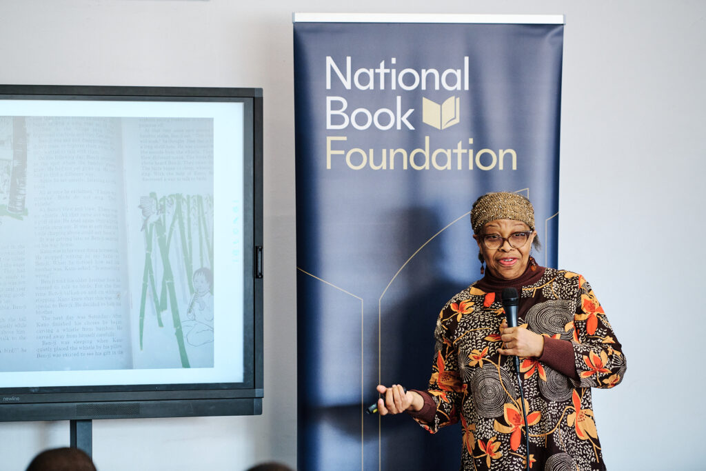 woman standing in front of room holding mic