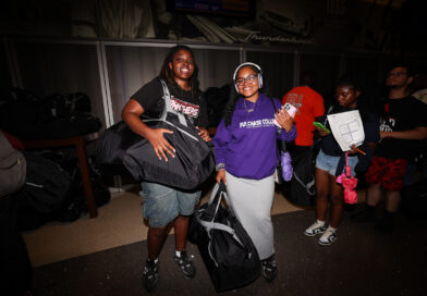 two people holding large duffel bags