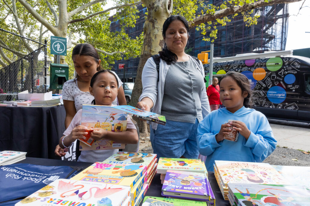 woman and children looking at books