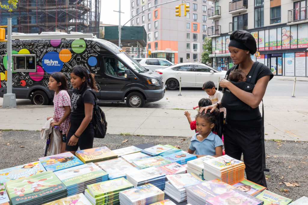 woman and children looking at books