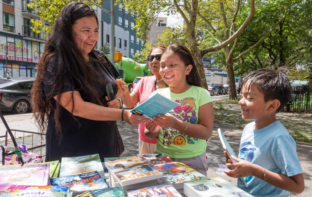 two women and children looking at books