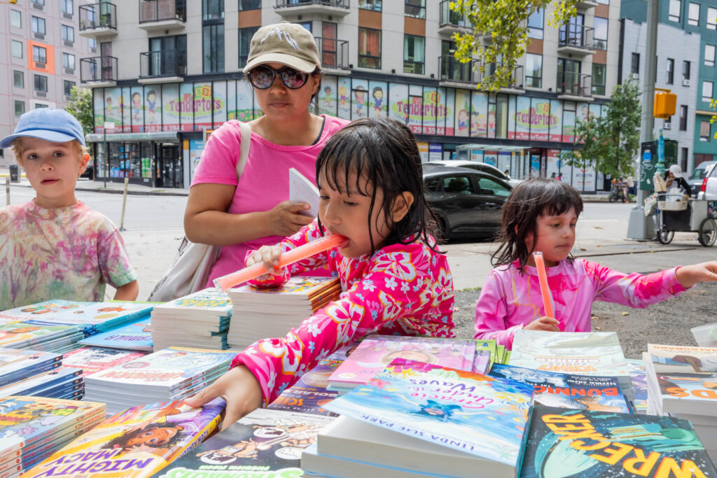 woman and children looking at books
