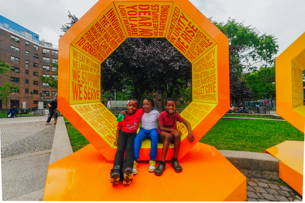 three children in front of art installation