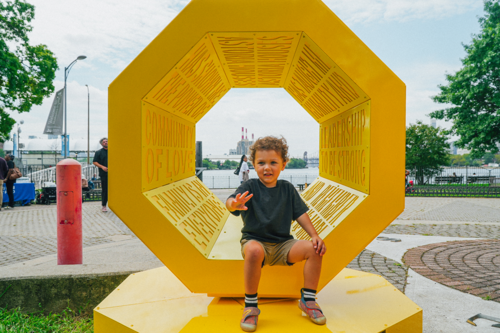 young child in front of art installation