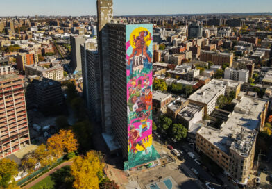 aerial view of a colorful mural on the side of a tall apartment building