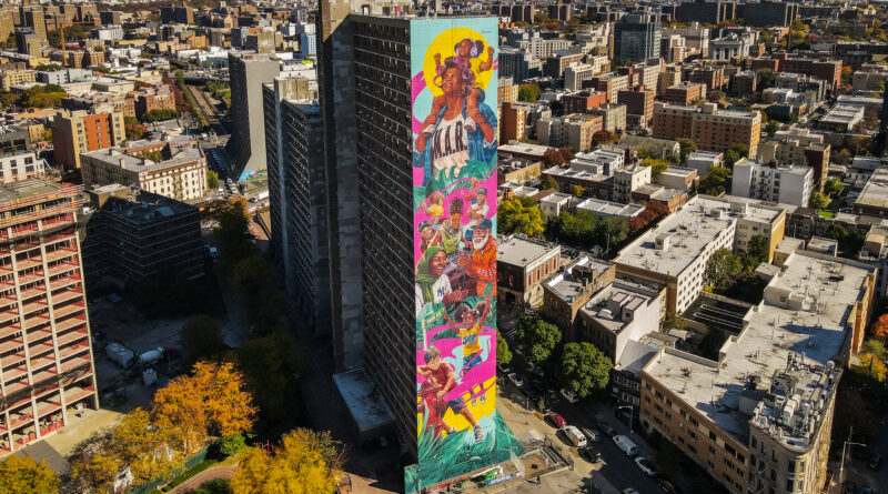 aerial view of a colorful mural on the side of a tall apartment building